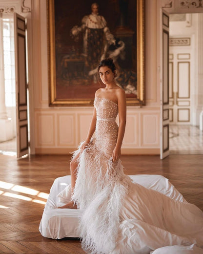 Sexy strapless corset wedding dress.Mermaid wedding dress with split slits with unique feathers.Beautiful pearl flower beaded wedding dress.